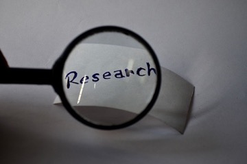 Photo of magnifying glass over the word research